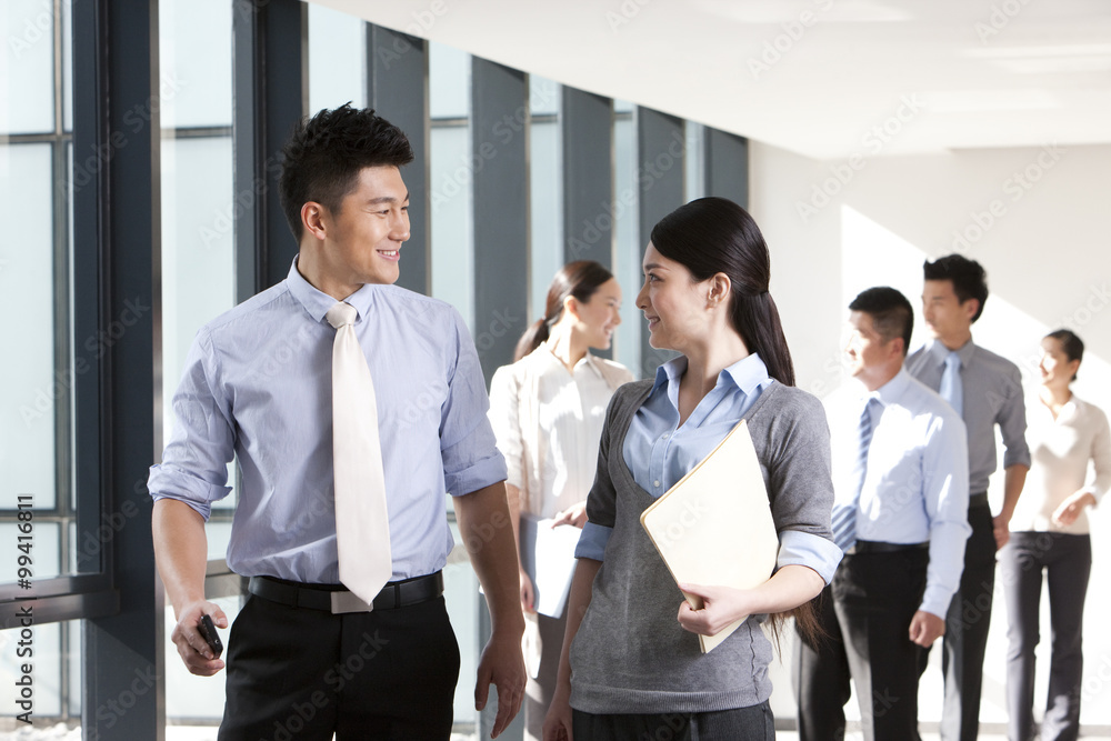 Businesspeople discussing matters in a hallway