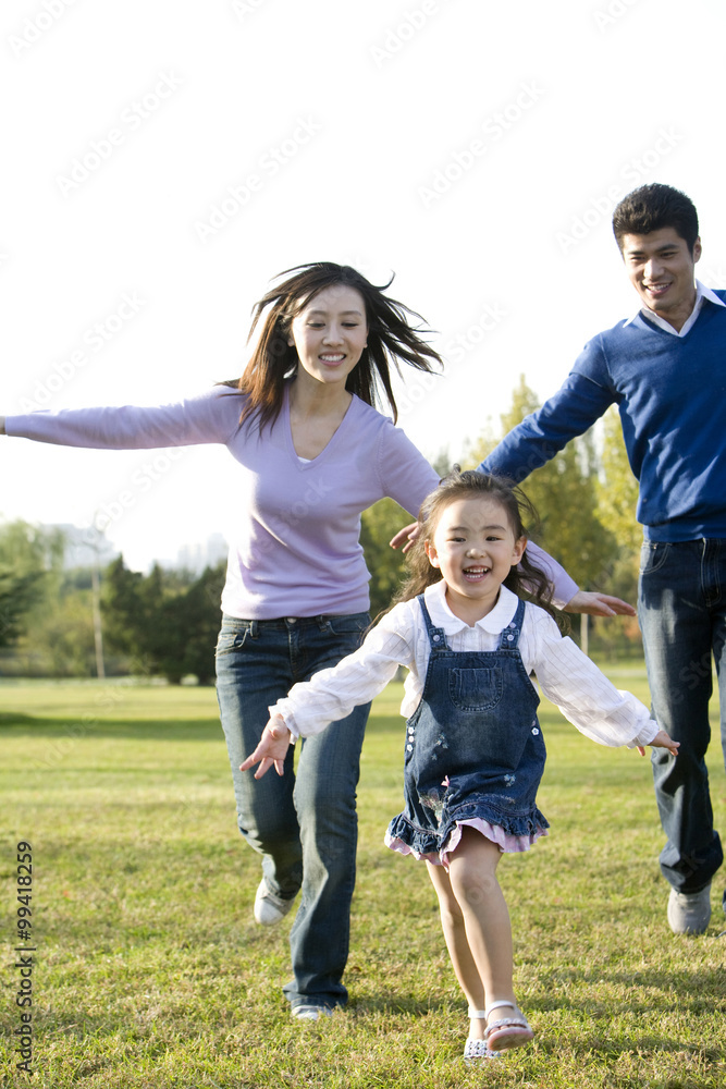 Young family playing in the park