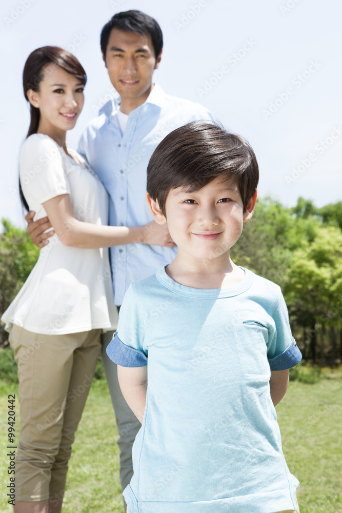 Portrait of young family on grass