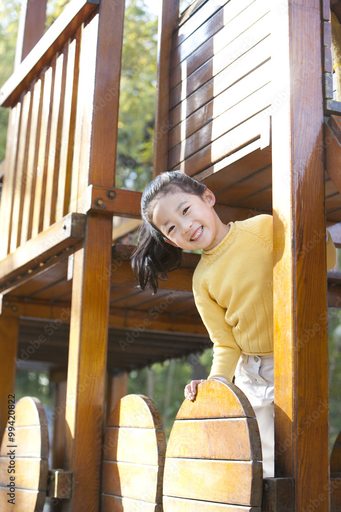 Girl playing on playground toys