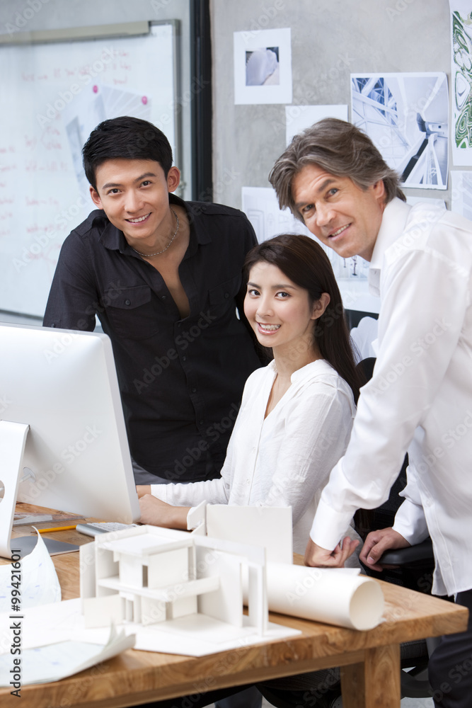  Architects working before computer in studio