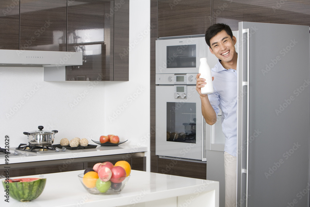 Man taking milk out of the fridge