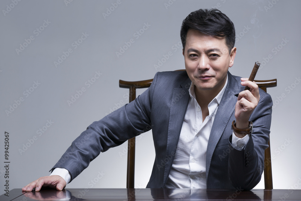 Mature businessman with cigar