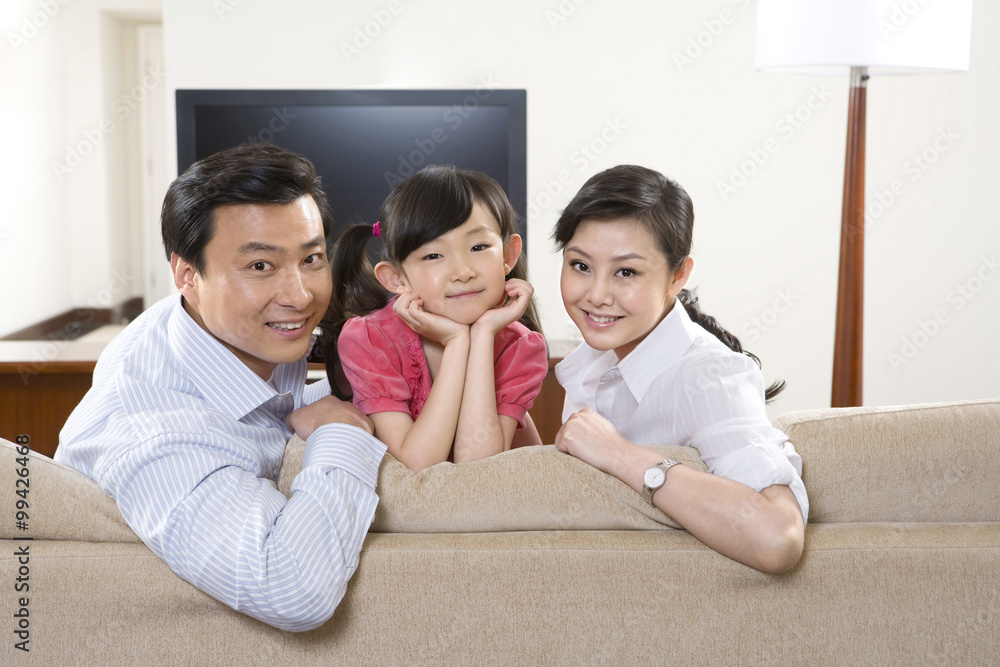 Couple with child in front of widescreen television