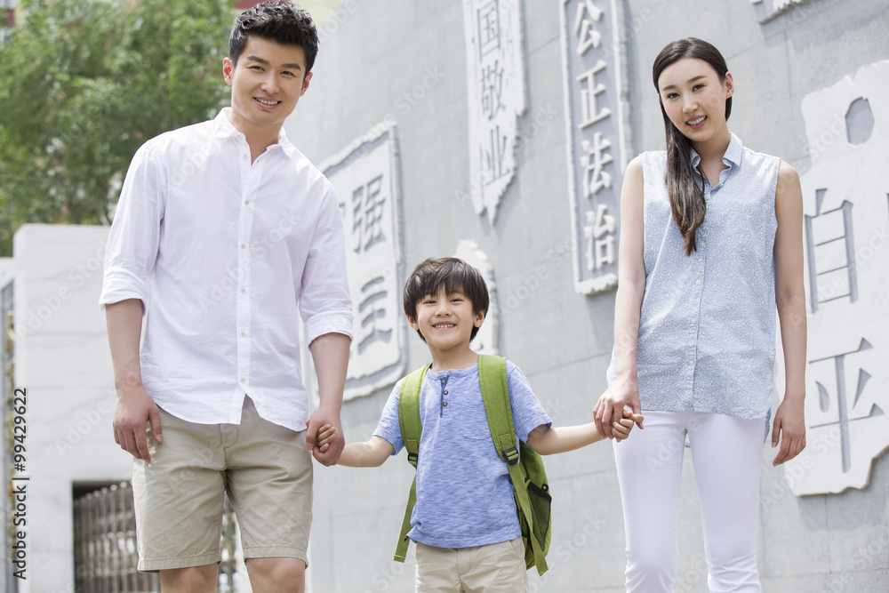 Happy schoolboy with his parents