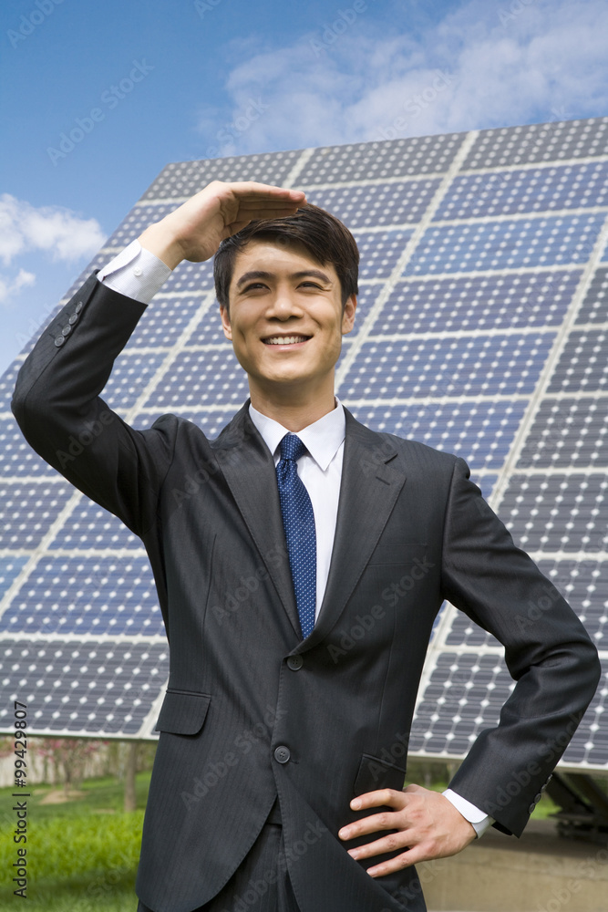 Portrait of a businessman in front of solar panels