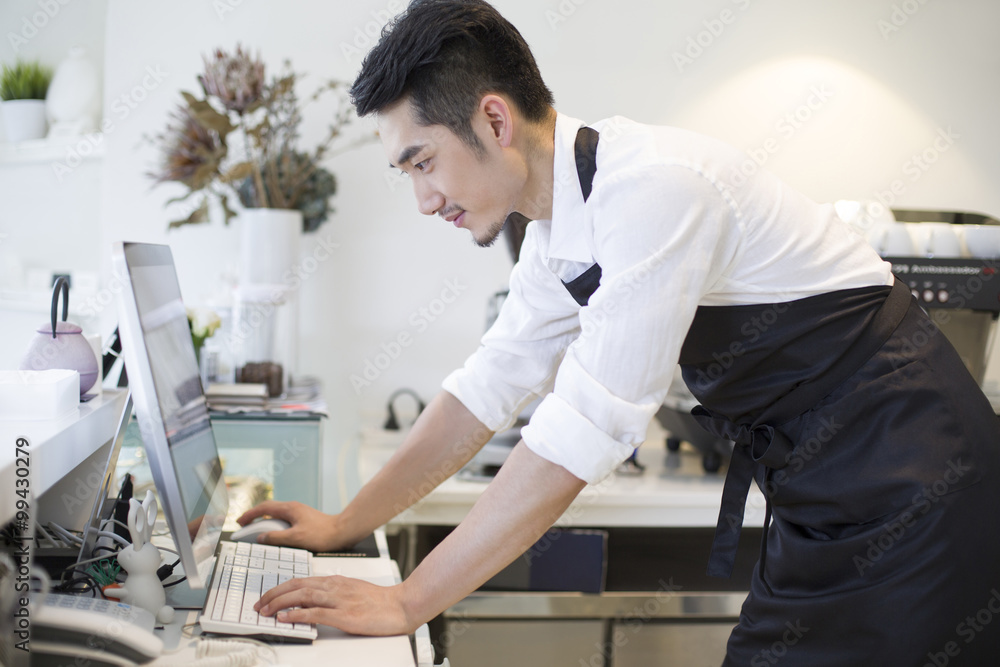 Coffee shop owner using computer