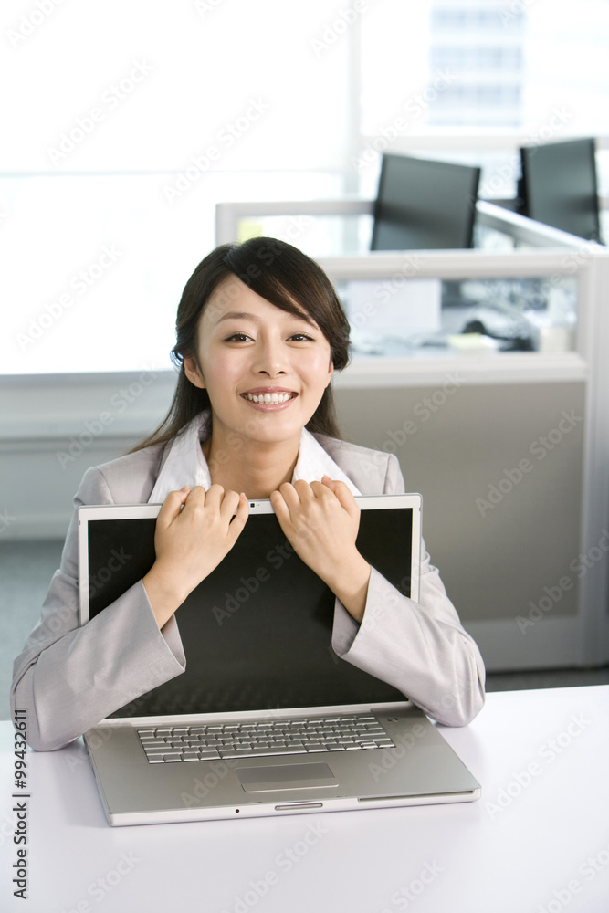 Office worker hugging her computer