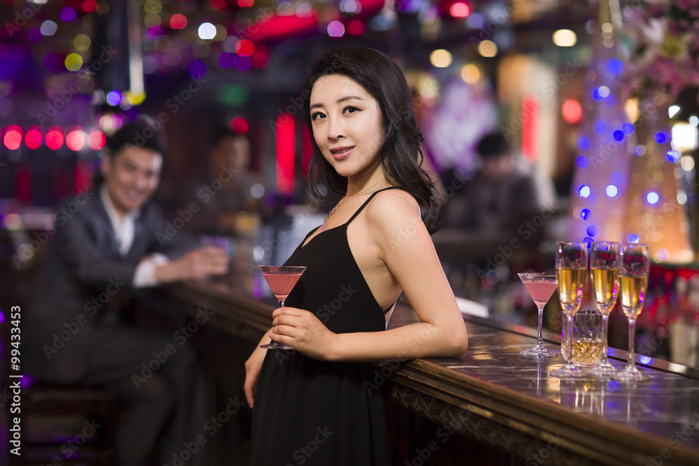 Cheerful young woman in bar