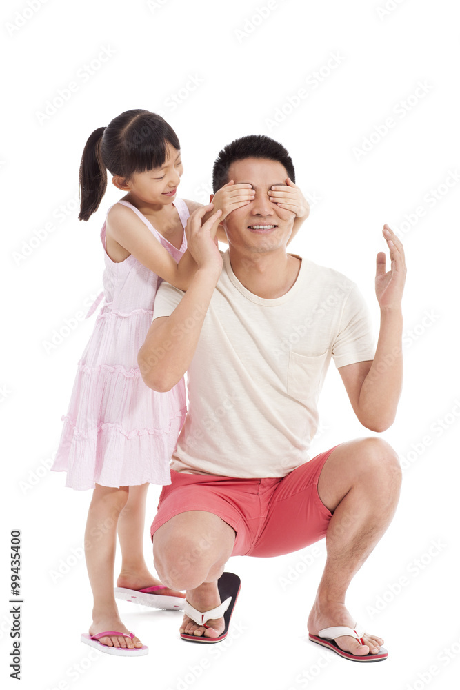 Little girl covering fathers eyes