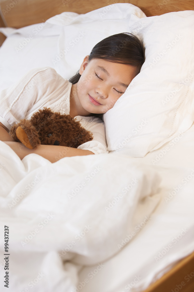 Little girl sleeping soundly with teddy bear