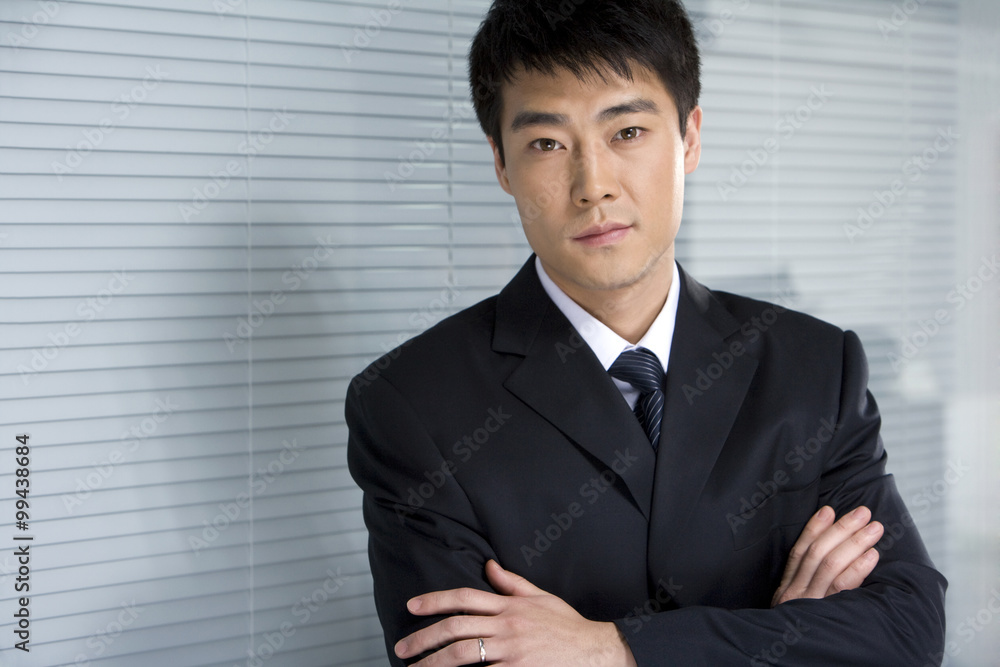 Businessman in front of blinds