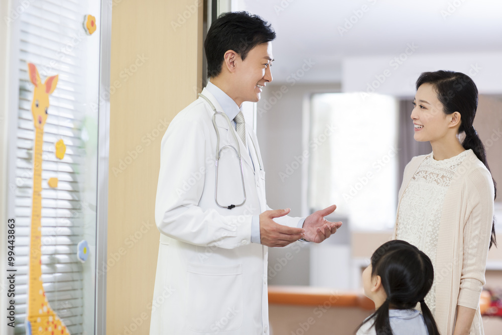 Doctor talking to girls mother in childrens hospital