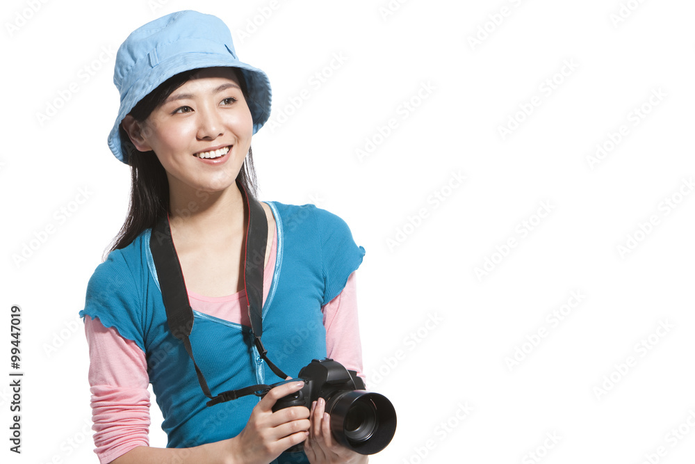 Portrait of a young woman holding a camera