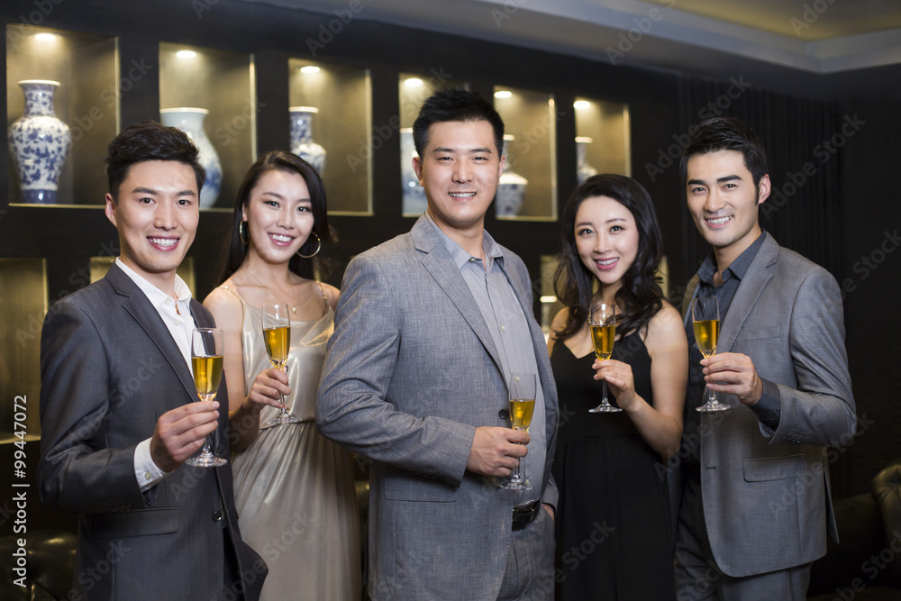 Cheerful adults drinking alcohol in luxury club