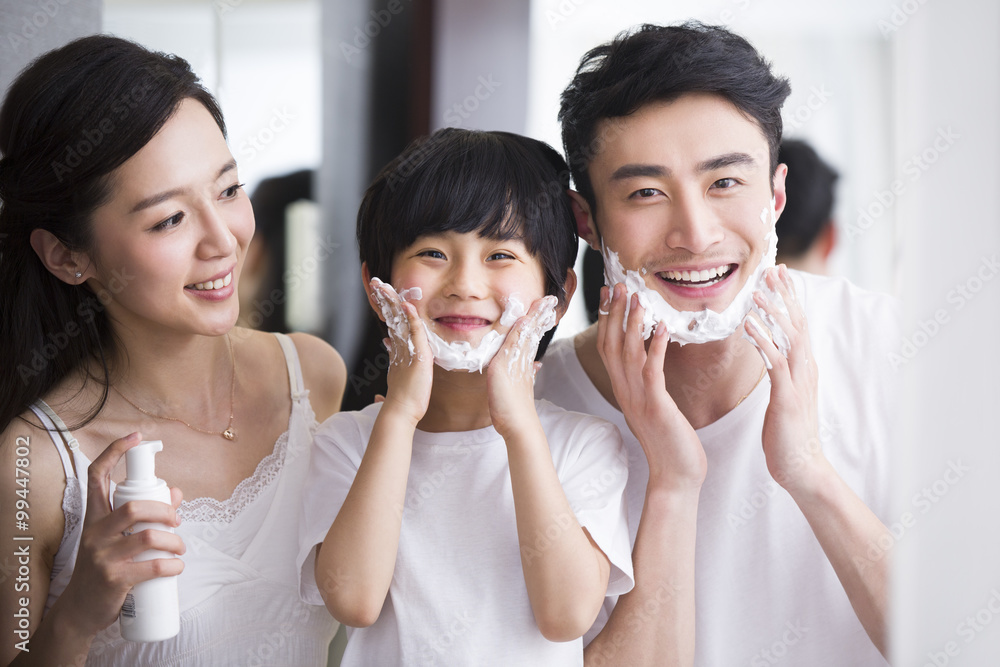 Family in bathroom with shaving cream on chin