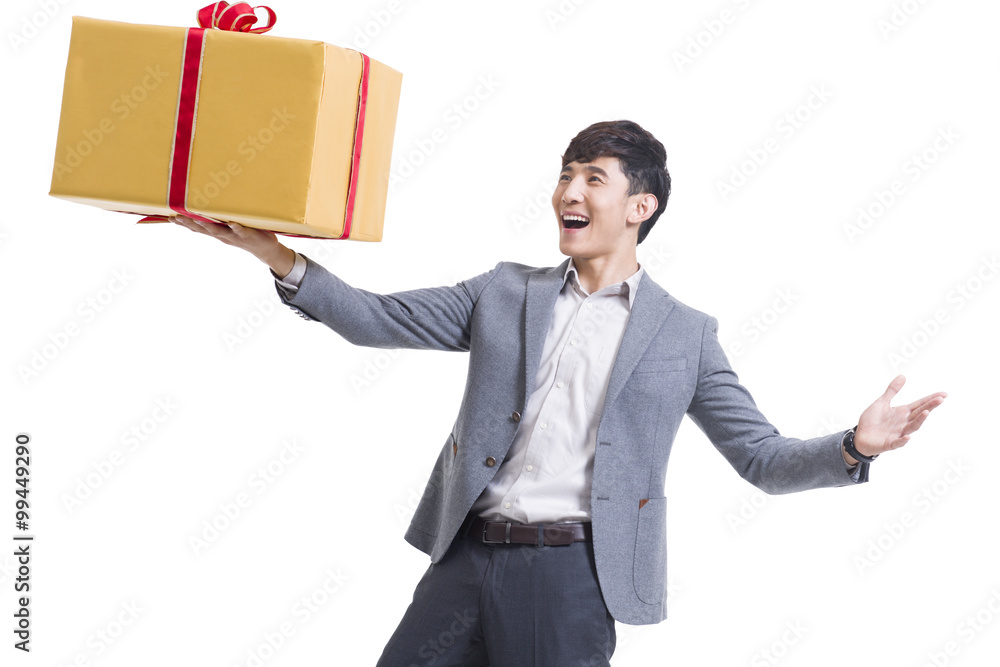 Happy young man holding a large gift