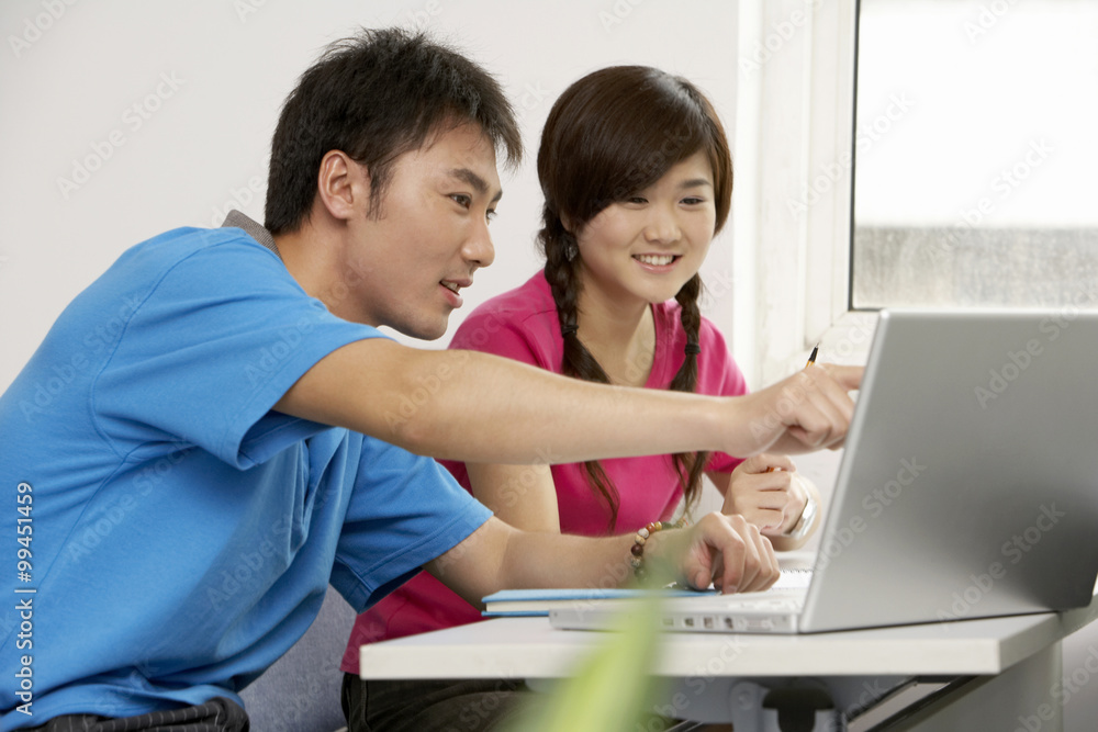 Students Looking At Laptop Computer Together