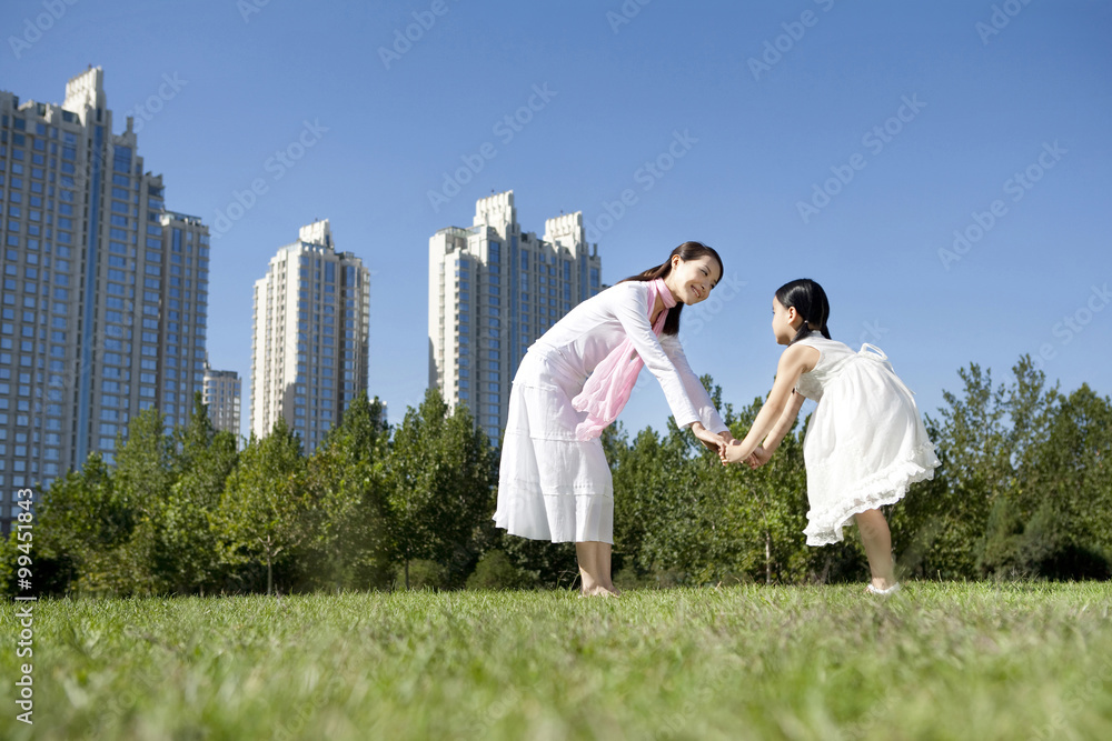 Mother and daughter playing in the park