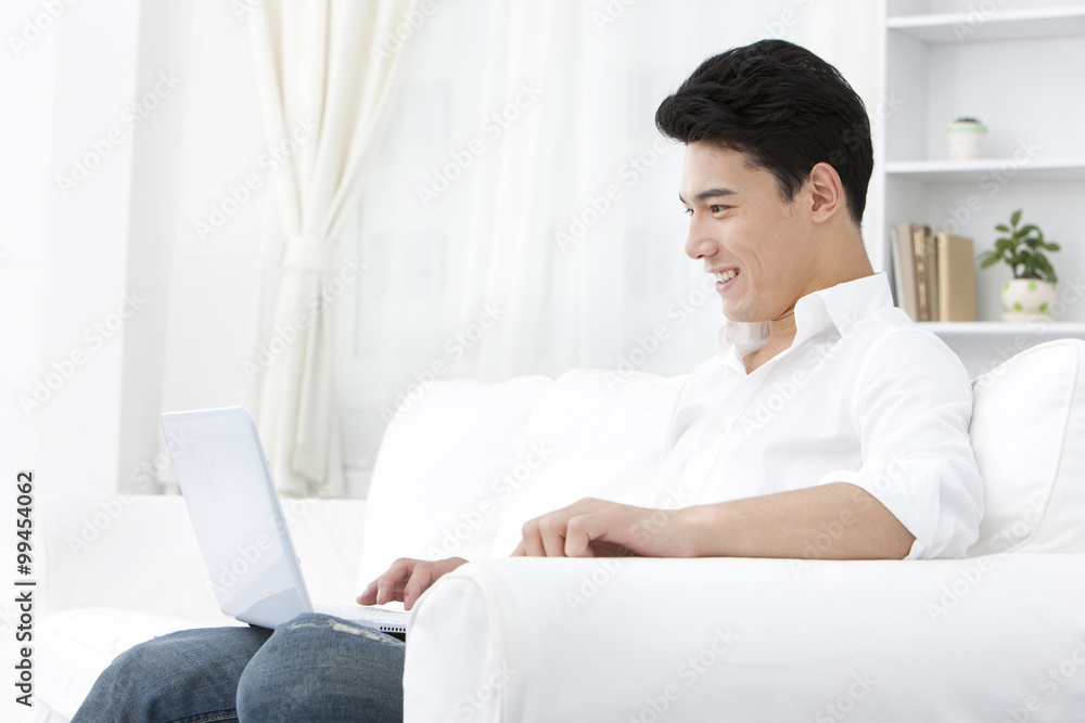 Young man using laptop at home