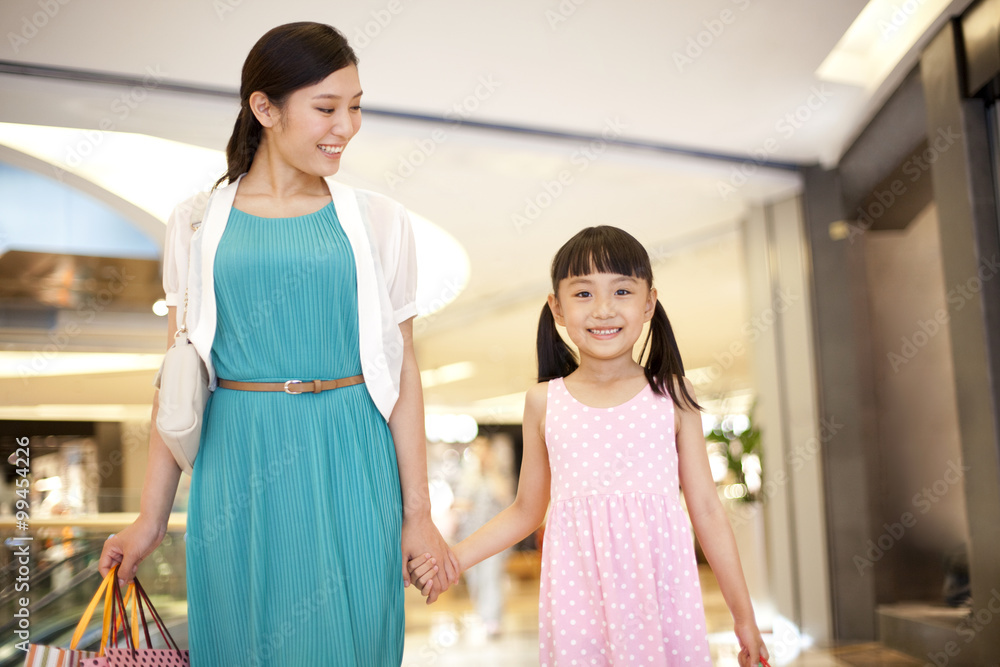 Mother and daughter shopping in department store