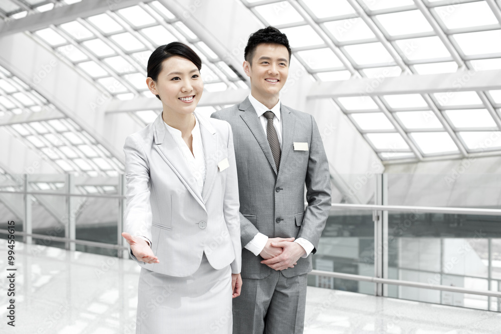 Young business partners with name tags at the airport