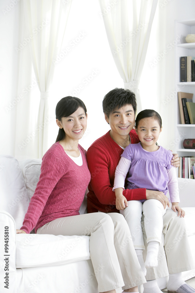 Young Chinese family in living room