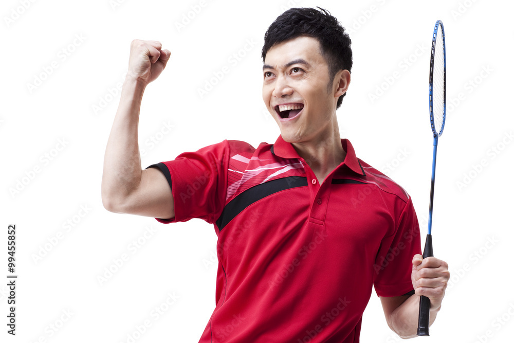 Male badminton player celebrating with excitement