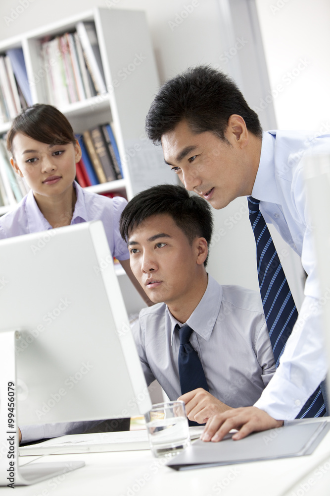 Businessmen working in front of a computer