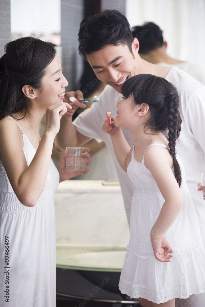 Happy family brushing teeth