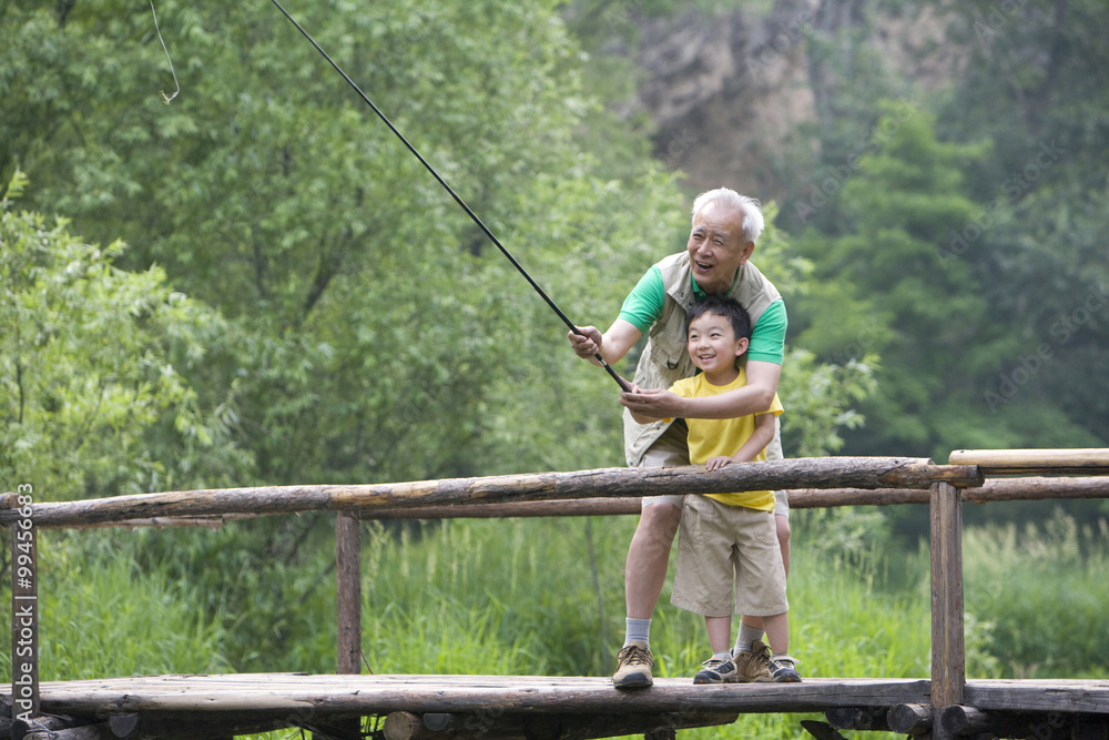 Grandfather and grandson fishing