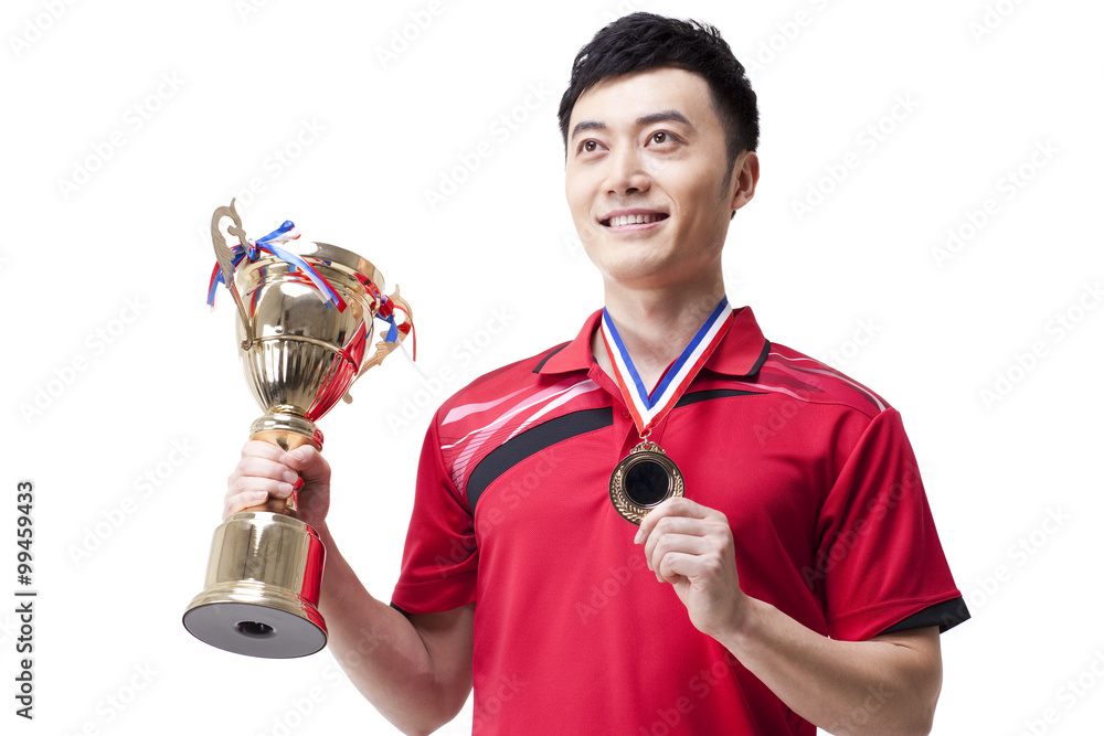 Male athlete celebrating victory with gold medal and trophy