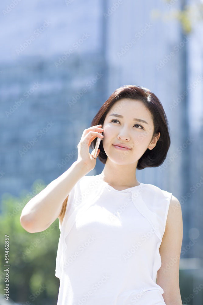 Happy young woman talking on the phone