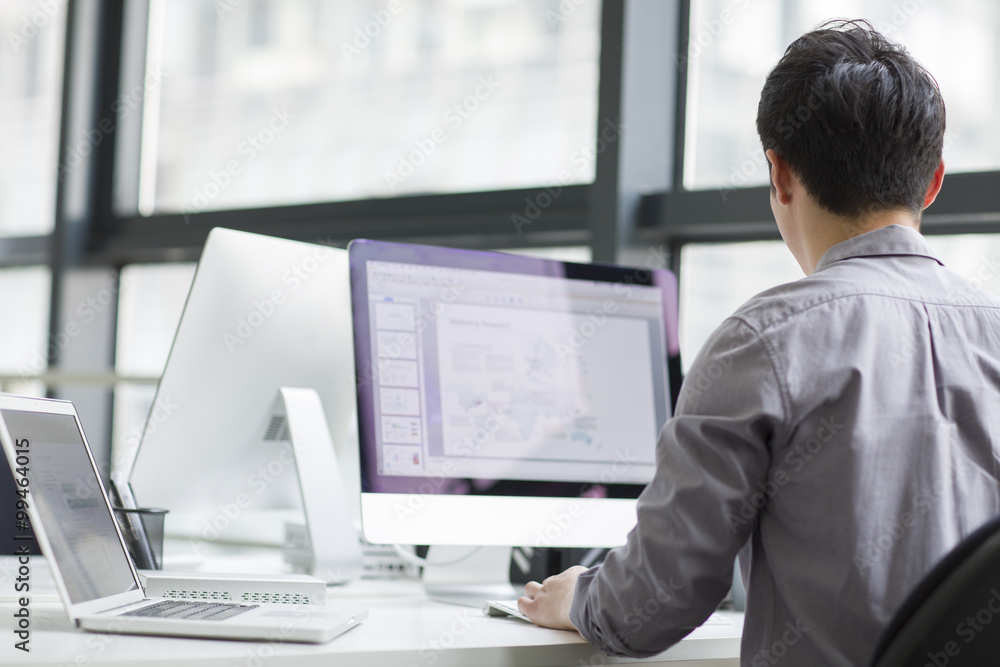 Young businessman using computer in office