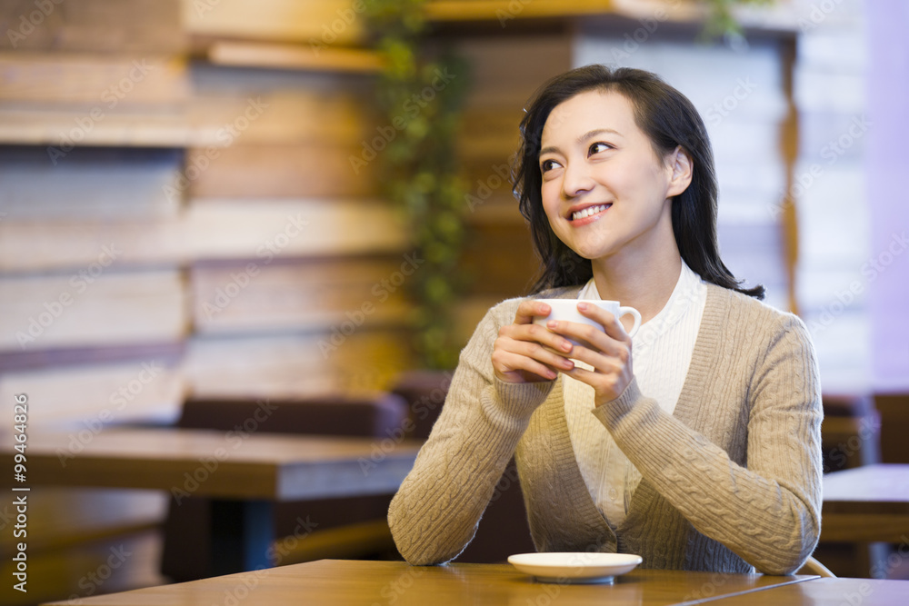 Young woman enjoying coffee in coffee shop