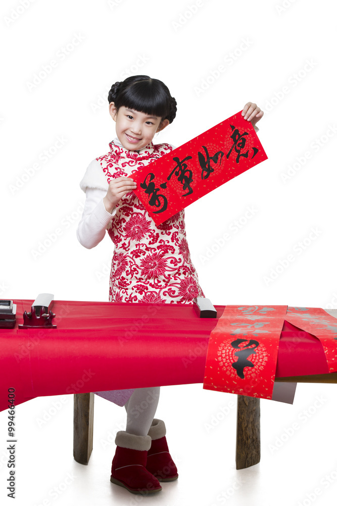 Happy girl showing her calligraphy on couplet