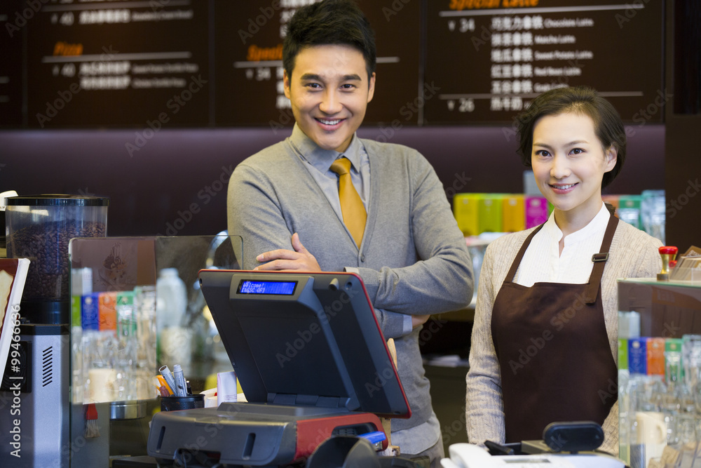 Portrait of coffee store shopkeeper and waitress