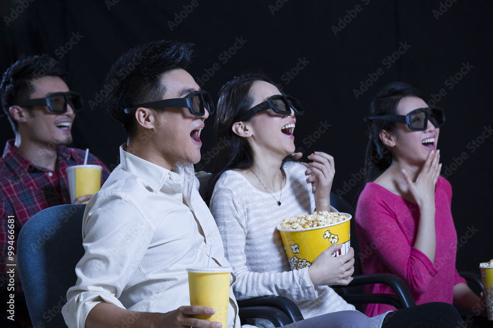 Young couple watching 3D movie in cinema