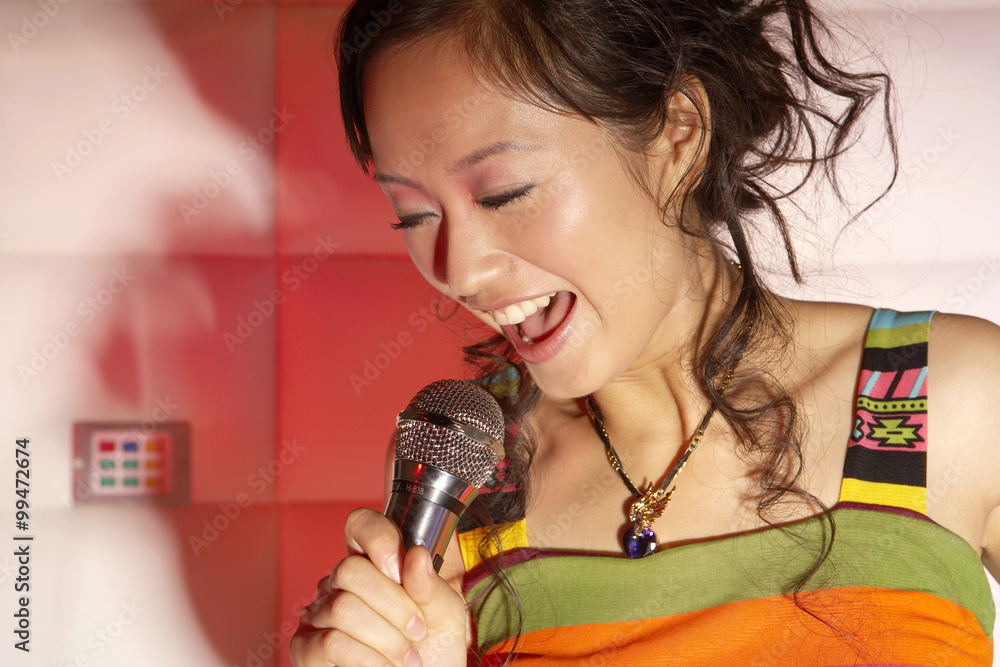 Young Woman Passionately Singing Karaoke