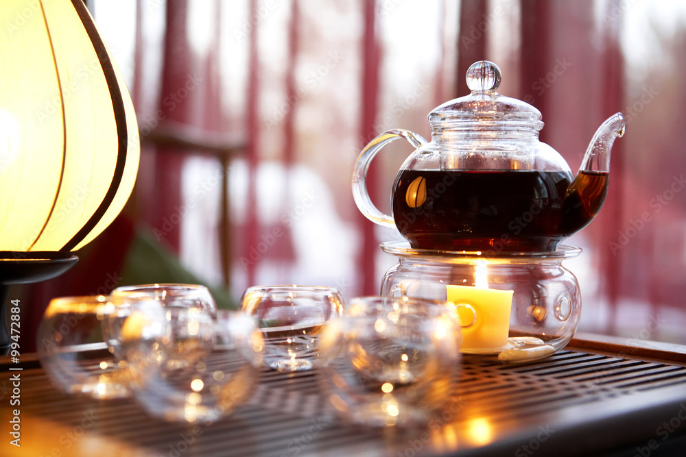 Tea Pot And Candle On Table