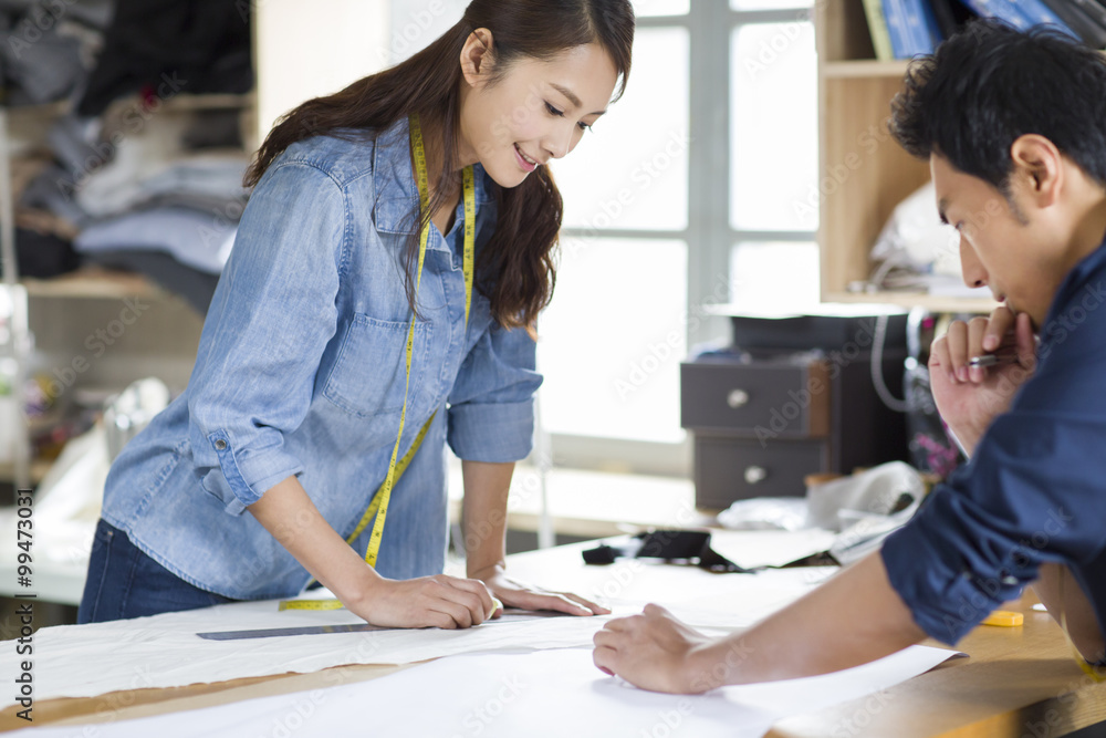 Two fashion designers working in studio