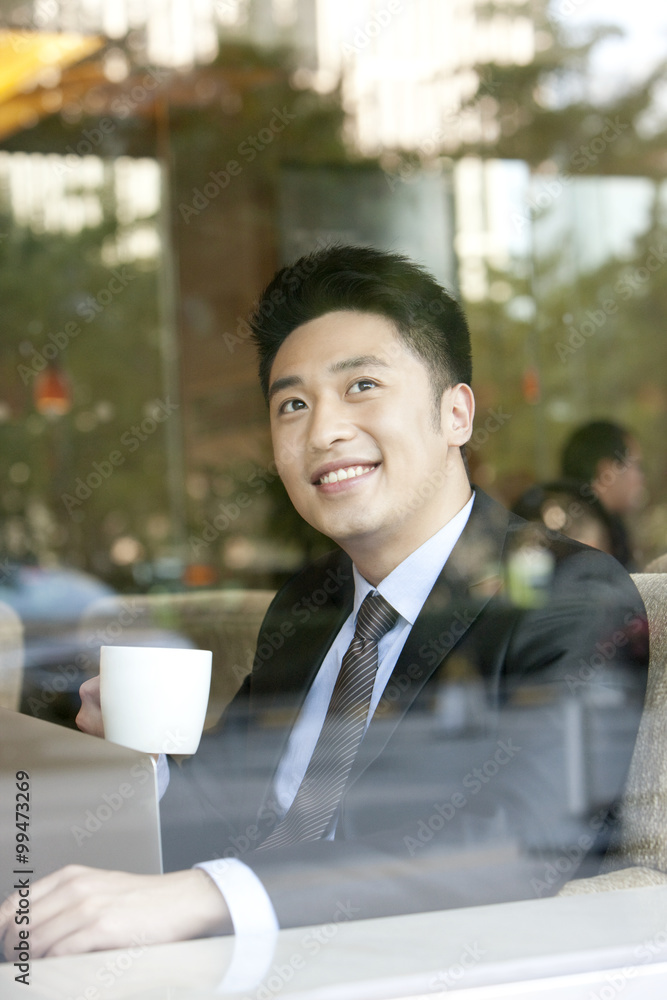 Businessman drinking coffee in cafe