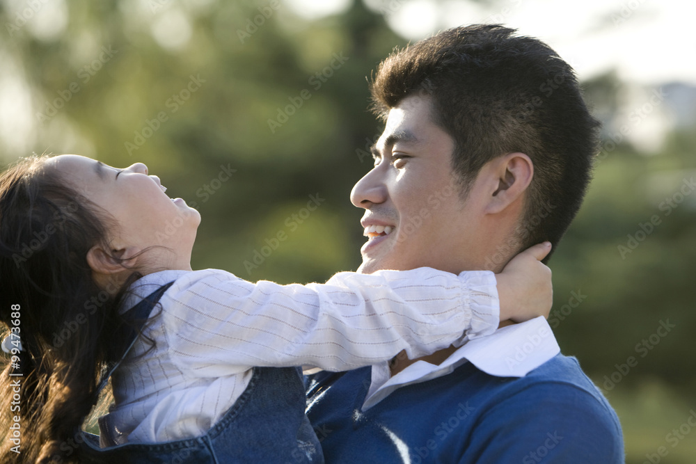 Portrait of father and daughter at the park