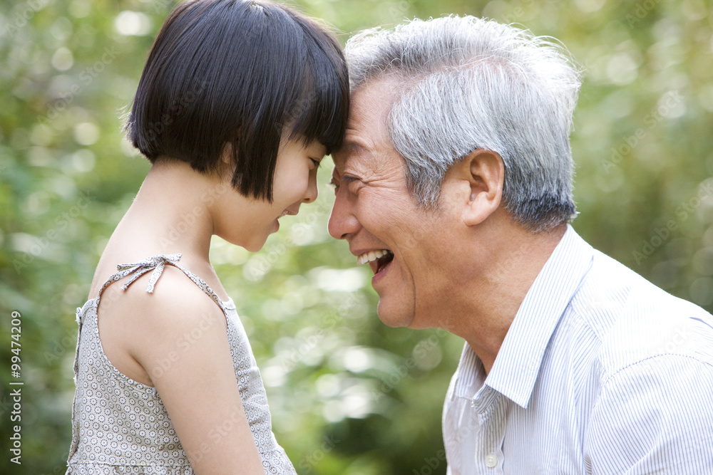 Grandpa and grandaughter having fun in garden