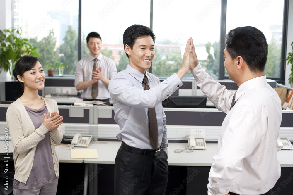 Office workers celebrating success