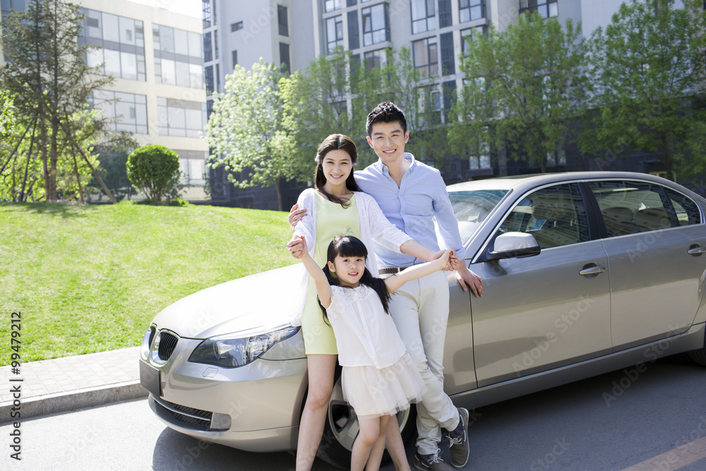 Happy young family and car