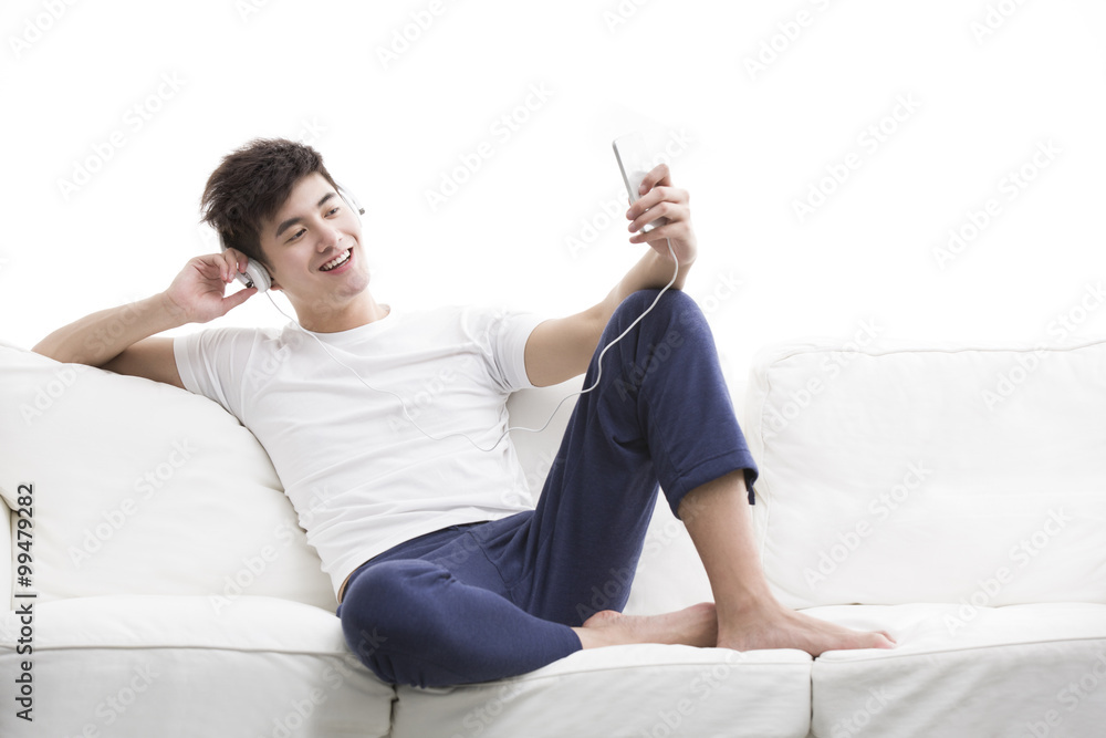 Young man listening to music on smart phone