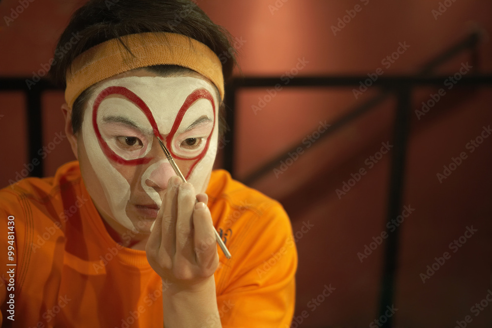 Performer Applying Face Paint With Brush