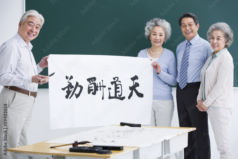 Senior adults having calligraphy class at school