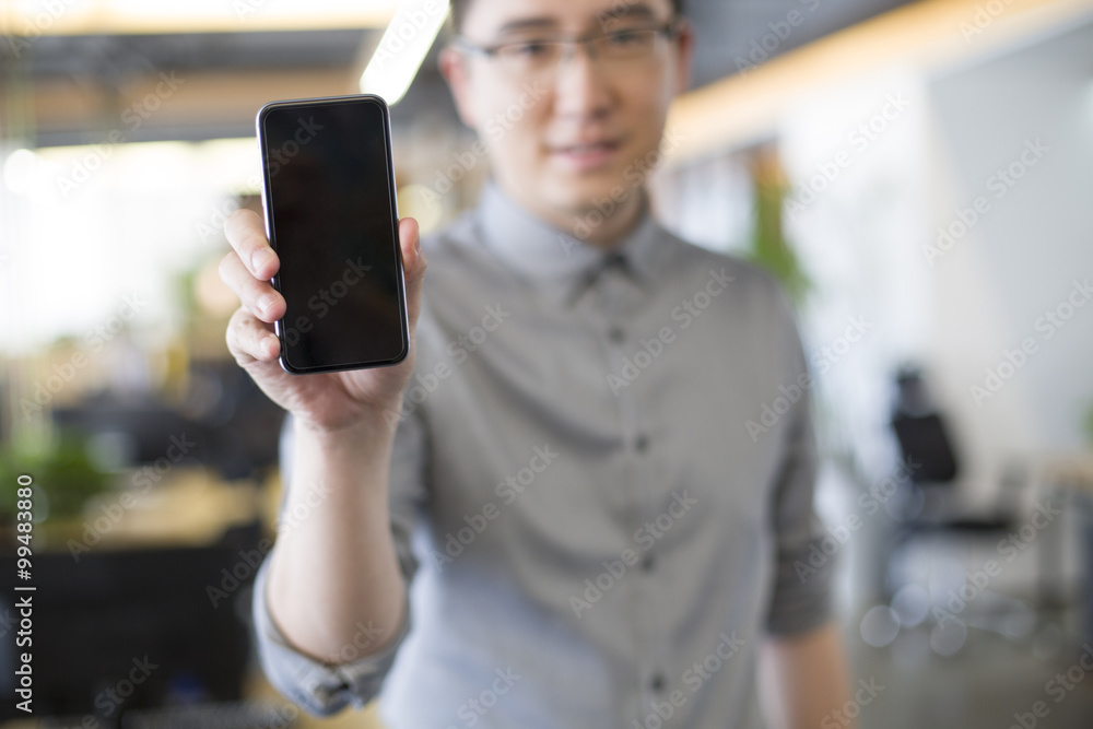 IT worker showing smart phone in office